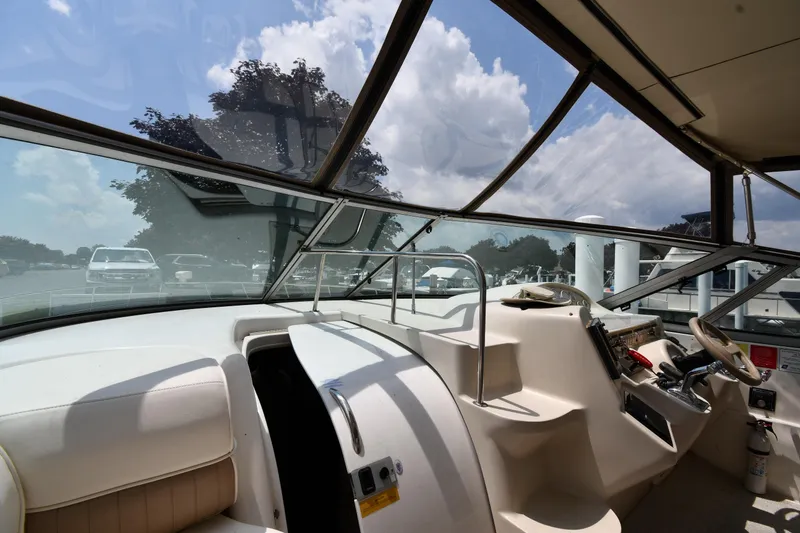 Slide: The Image of 1998 Cruisers Yachts 3870 Express helm station with panoramic windshield view. - 8