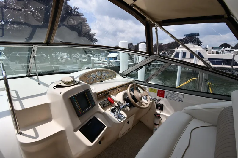 Slide: The Image of 1998 Cruisers Yachts 3870 Express helm with navigation equipment and steering wheel. - 9