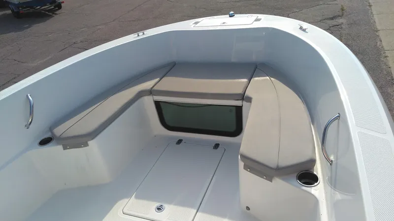 Slide: The Image of 2021 Wellcraft 202 Fisherman boat interior with cushioned seating and storage compartments. - 19
