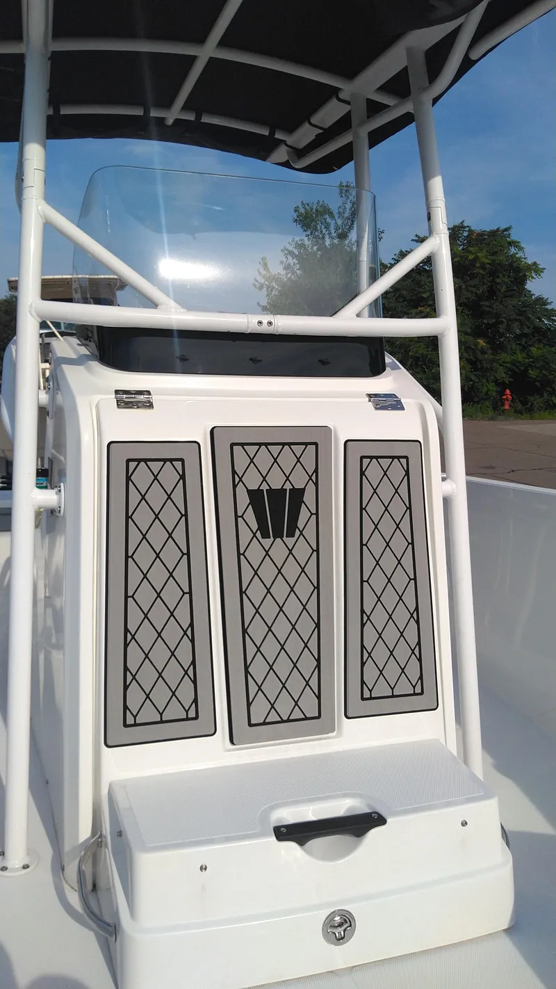 Slide: The Image of 2021 Wellcraft 202 Fisherman center console with storage compartments and T-top. - 21