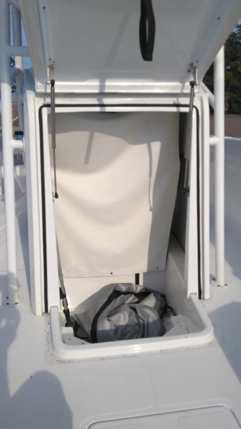 Slide: The Image of 2021 Wellcraft 202 Fisherman storage compartment with open hatch. - 22