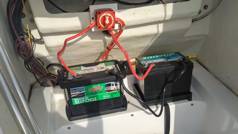 Slide: The Image of 2021 Wellcraft 202 Fisherman boat battery compartment with deep cycle batteries and wiring. - 23