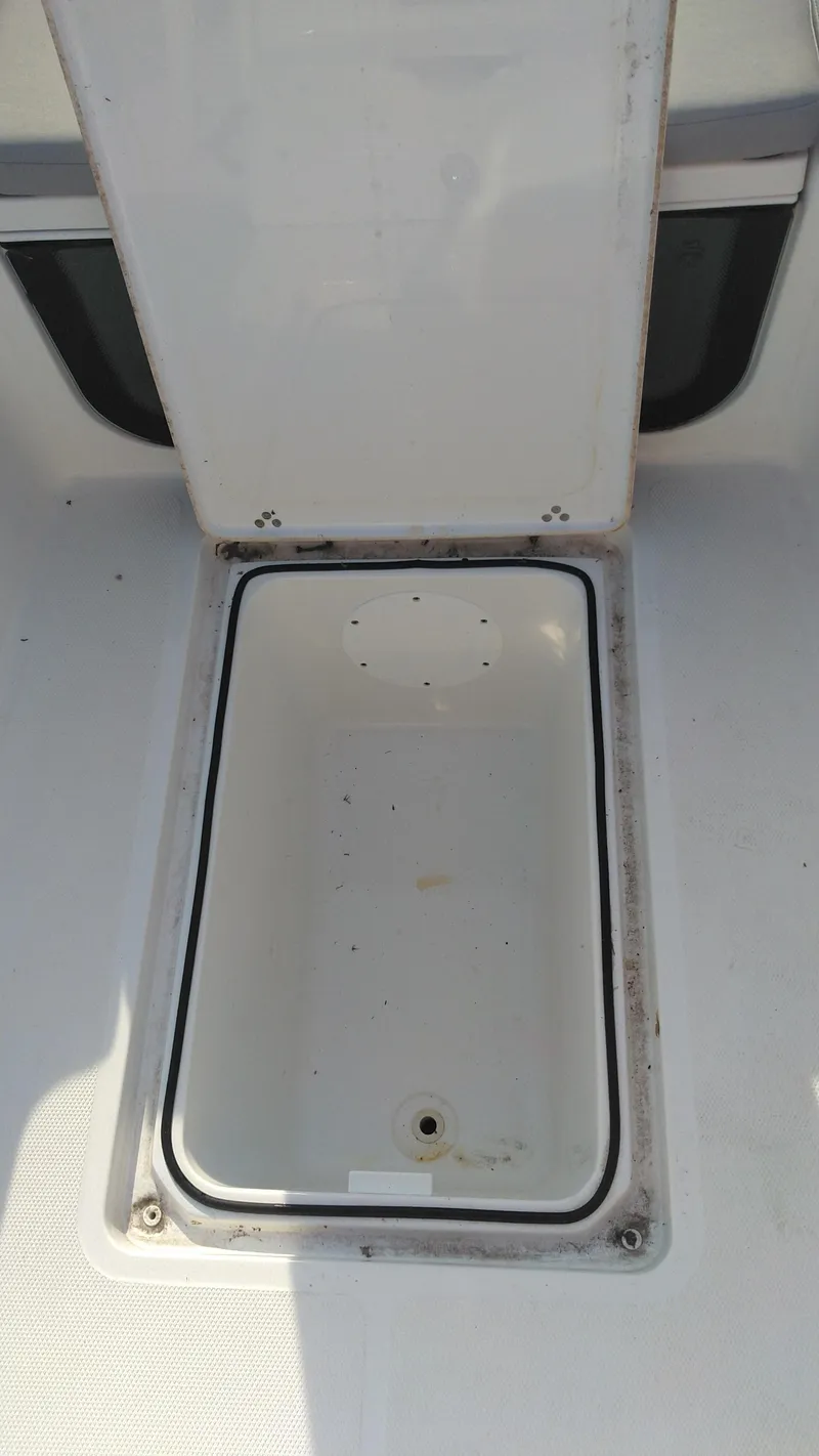 Slide: The Image of Open storage compartment on a 2021 Wellcraft 202 Fisherman boat. - 28