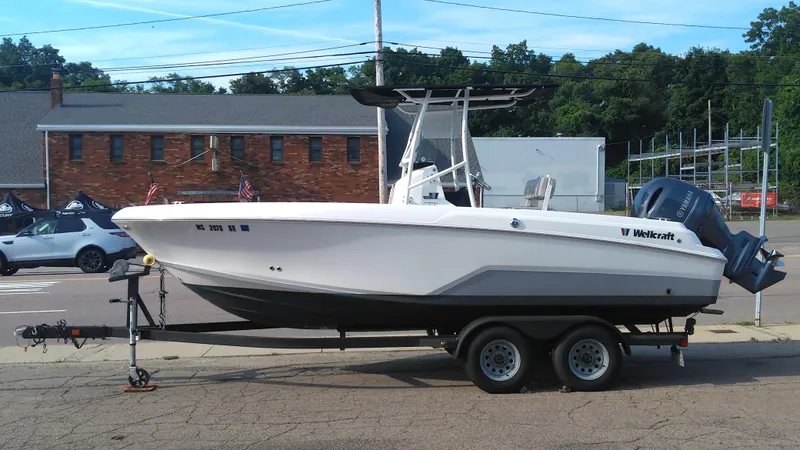 Slide: The Image of 2021 Wellcraft 202 Fisherman boat on a trailer in a parking lot. - 3