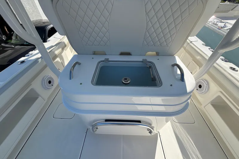 Slide: The Image of 2026 World Cat 295 CC boat interior with seating and storage compartment. - 10