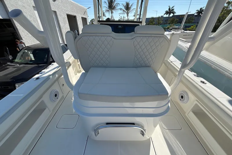 Slide: The Image of 2026 World Cat 295 CC boat interior with white cushioned seating and sleek design. - 11