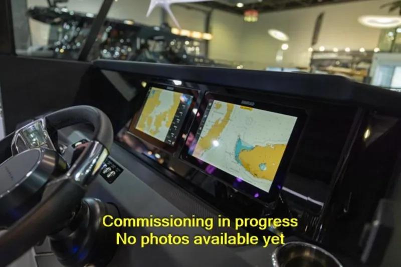 Slide: The Image of 2024 Axopar 29 XC Cross Cabin dashboard with navigation screens, commissioning in progress. - 3