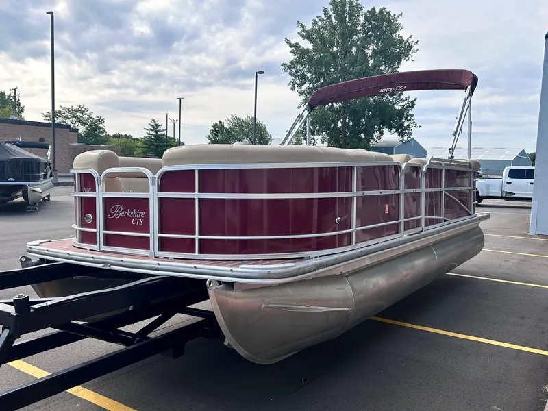 Slide: The Image of 2015 Berkshire 210CL CTS pontoon boat on trailer in parking lot. - 0
