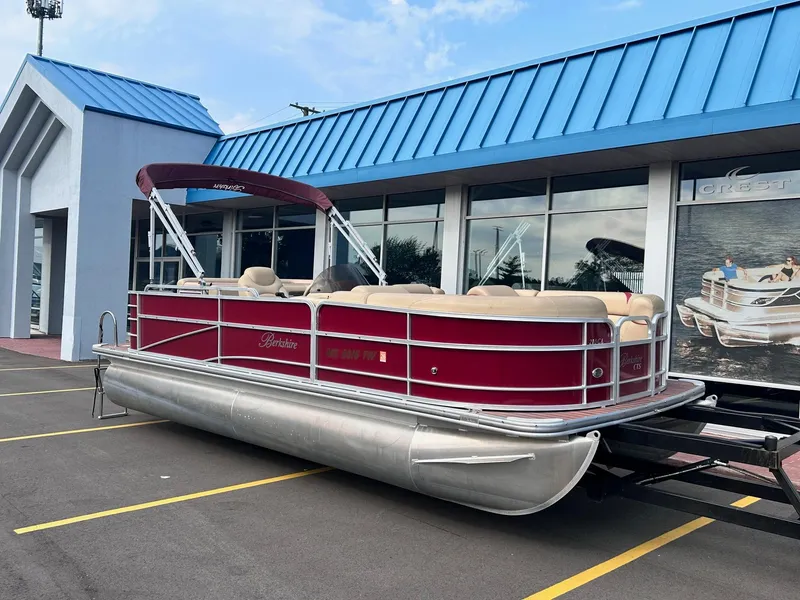 Slide: The Image of 2015 Berkshire 210CL CTS pontoon boat with red exterior parked outside a dealership. - 1