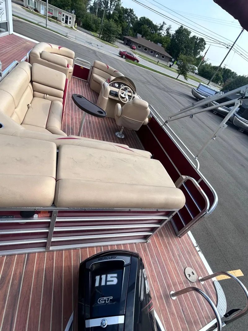 Slide: The Image of 2015 Berkshire 210CL CTS pontoon boat with beige seating and 115 HP engine. - 10
