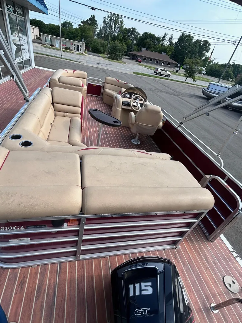 Slide: The Image of 2015 Berkshire 210CL CTS pontoon boat with beige seating and 115 HP outboard motor. - 11