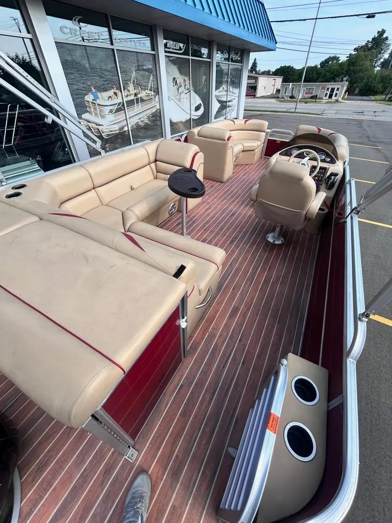 Slide: The Image of 2015 Berkshire 210CL CTS pontoon boat with beige seating and wood flooring. - 12