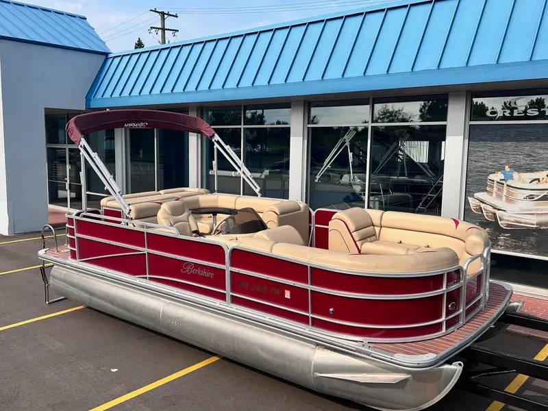 Slide: The Image of 2015 Berkshire 210CL CTS pontoon boat with red exterior and beige seating. - 2