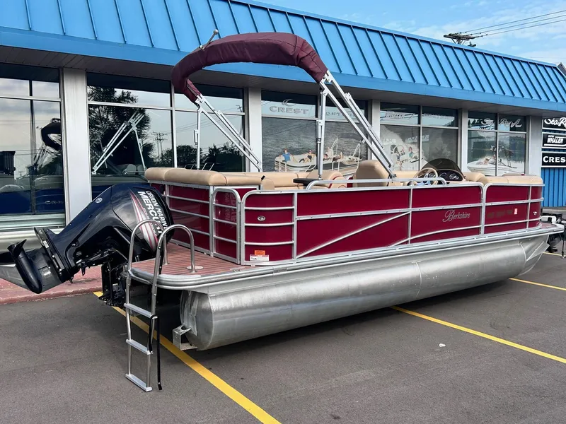 Slide: The Image of 2015 Berkshire 210CL CTS pontoon boat with maroon exterior and outboard motor. - 6