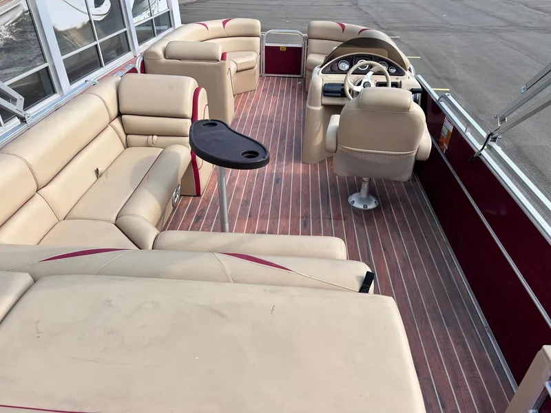 Slide: The Image of 2015 Berkshire 210CL CTS pontoon boat with beige seating and wood-like flooring. - 8
