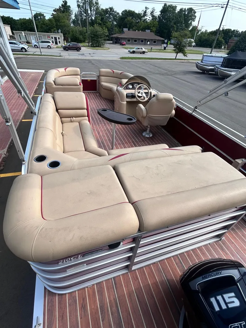 Slide: The Image of 2015 Berkshire 210CL CTS pontoon boat with beige seating and a 115 HP motor. - 9