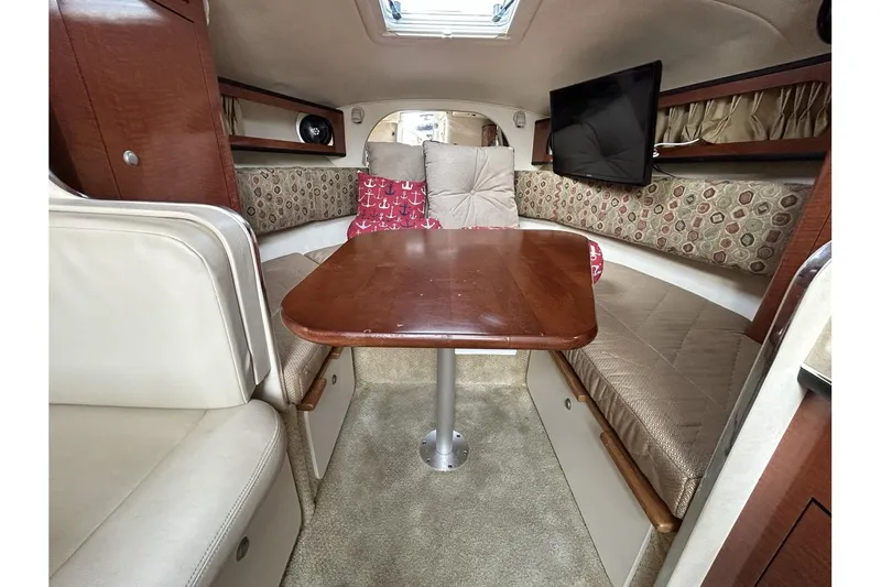 Slide: The Image of Interior of 2005 Sea Ray 280 Sundancer with cozy seating and table. - 13