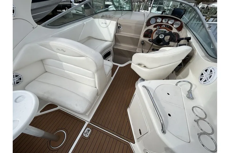 Slide: The Image of 2005 Sea Ray 280 Sundancer interior with white seating and wood flooring. - 7