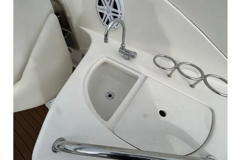 Slide: The Image of 2005 Sea Ray 280 Sundancer boat sink and cup holders on deck. - 8