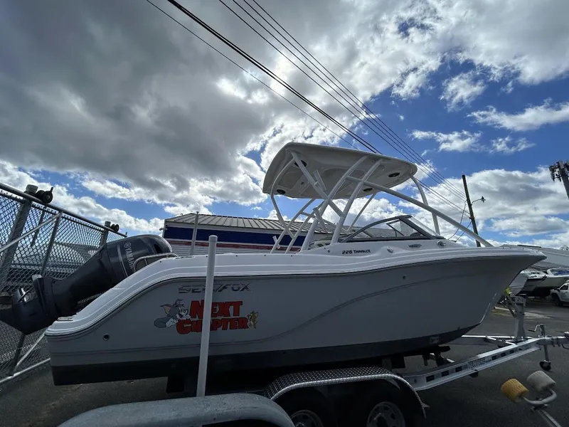 The Image of 2023 Sea Fox 226 Traveler boat on trailer under cloudy sky. - 0