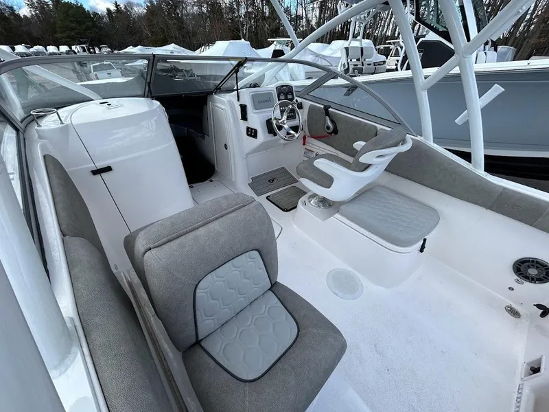 Slide: The Image of 2023 Sea Fox 226 Traveler boat interior with gray seating and modern dashboard. - 11