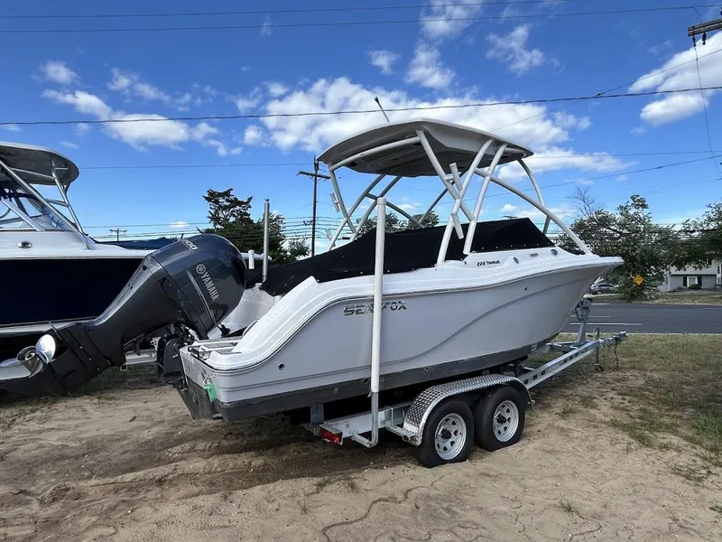Slide: The Image of 2023 Sea Fox 226 Traveler boat on trailer under blue sky. - 8