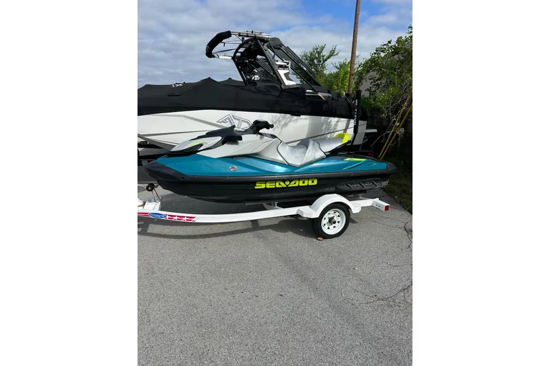 The Image of 2024 Sea-Doo GTI SE 130 jet ski on trailer, parked outdoors. - 2
