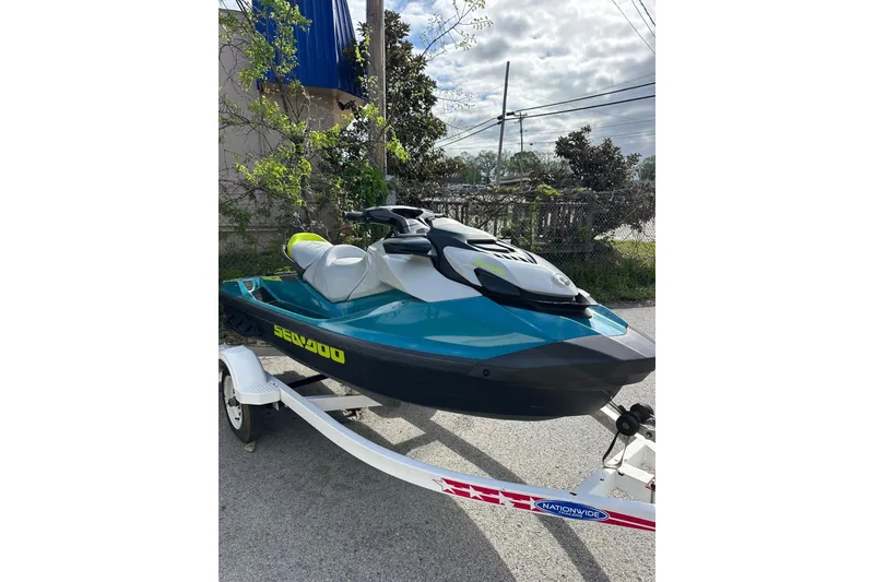 Slide: The Image of 2024 Sea-Doo GTI SE 130 jet ski on trailer, parked outdoors. - 4