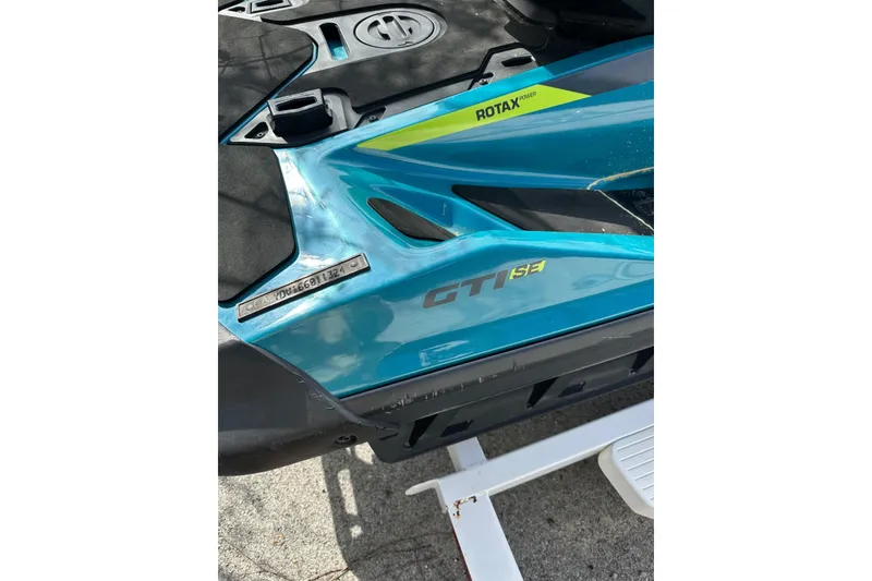 Slide: The Image of 2024 Sea-Doo GTI SE 130 jet ski with Rotax engine, blue and black design. - 6