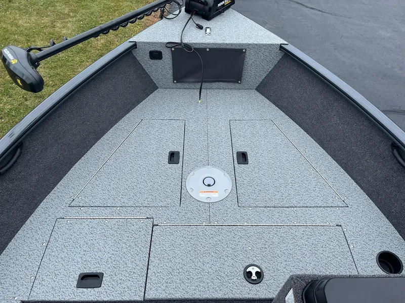 Slide: The Image of 2025 Lund 1650 Rebel XL SS boat deck with storage compartments and trolling motor. - 10