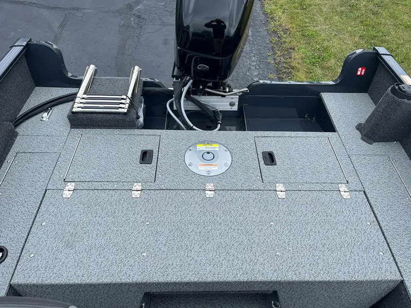 Slide: The Image of 2025 Lund 1650 Rebel XL SS boat interior with motor and storage compartments. - 11