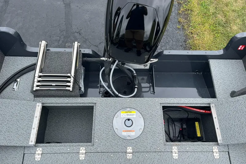 Slide: The Image of 2025 Lund 1650 Rebel XL SS boat interior with motor and storage compartments. - 12