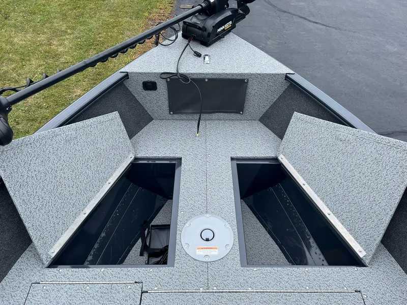 Slide: The Image of 2025 Lund 1650 Rebel XL SS boat interior with open storage compartments. - 14