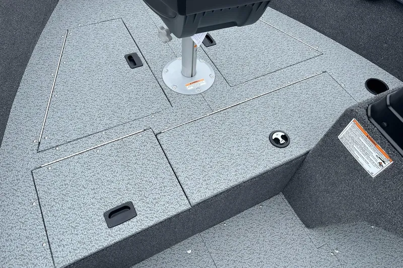 Slide: The Image of 2025 Lund 1650 Rebel XL SS boat deck with storage compartments and seat base. - 15