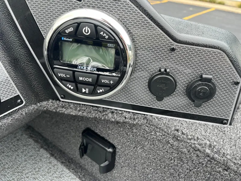 Slide: The Image of 2025 Lund 1650 Rebel XL SS dashboard with audio controls and power outlets. - 24