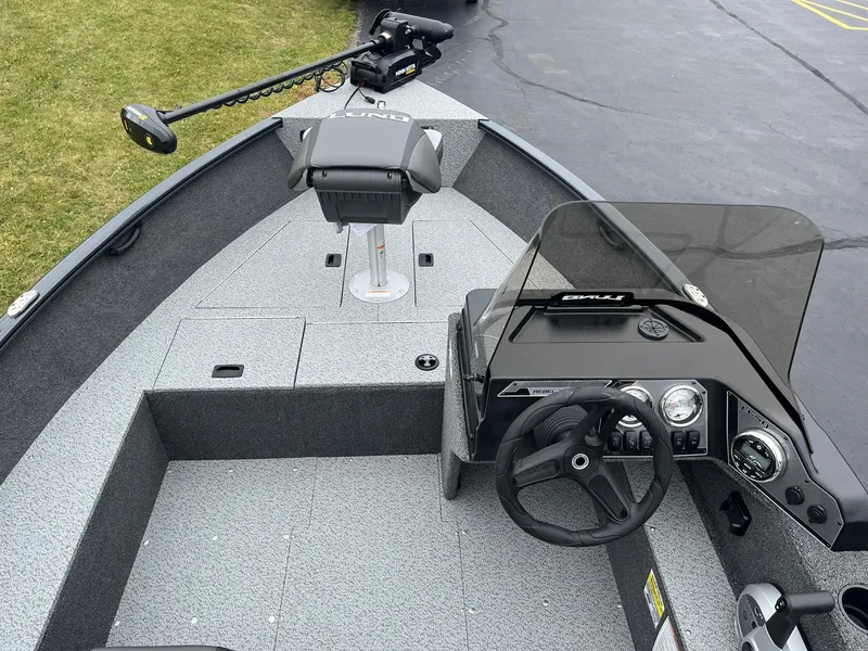 Slide: The Image of 2025 Lund 1650 Rebel XL SS boat interior with steering wheel and seating. - 7