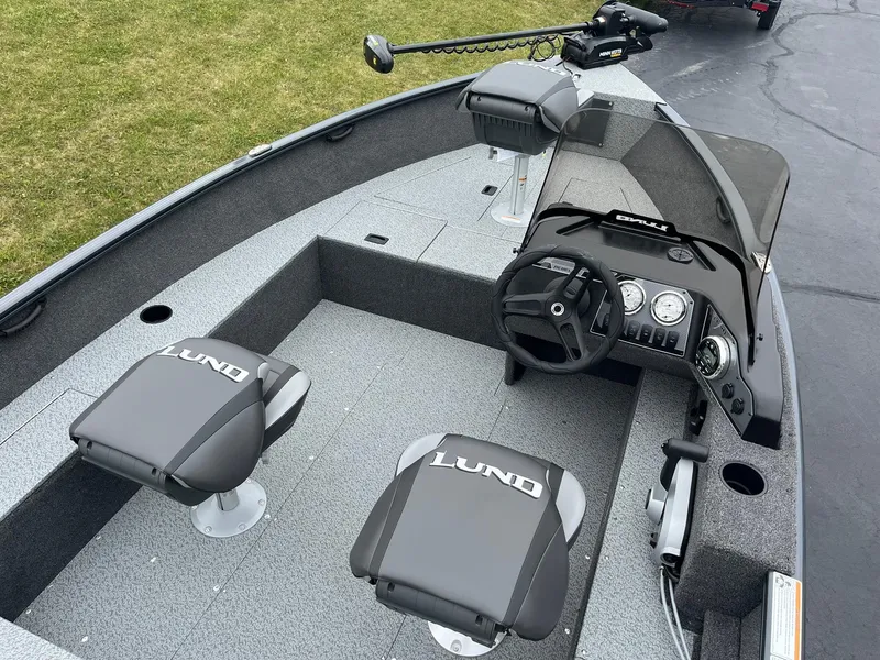 Slide: The Image of 2025 Lund 1650 Rebel XL SS boat interior with steering console and seating. - 8