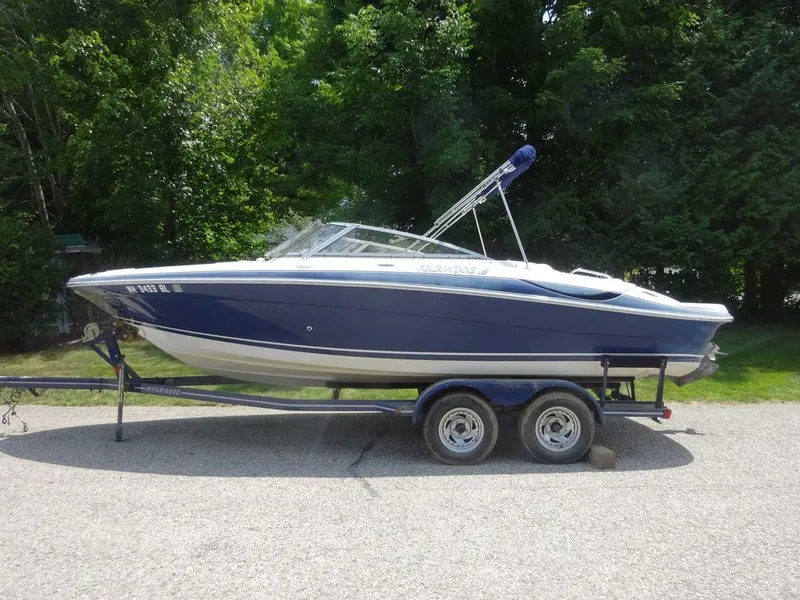 Slide: The Image of 2006 Four Winns H220 boat on trailer, parked on a sunny day. - 1