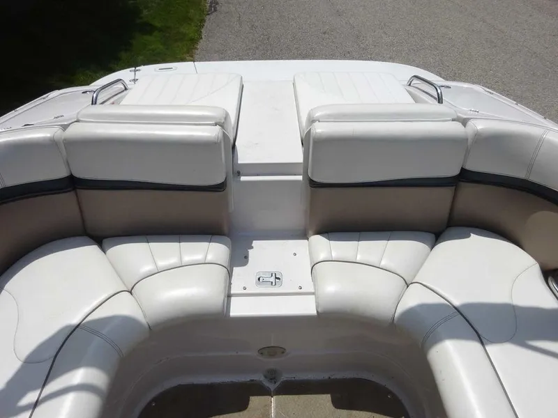 Slide: The Image of 2006 Four Winns H220 boat interior with white leather seating and sleek design. - 11