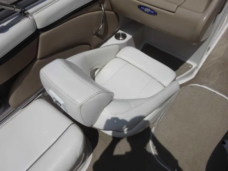 Slide: The Image of 2006 Four Winns H220 boat interior with white seating and cup holder. - 12