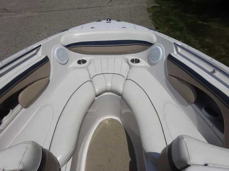 Slide: The Image of 2006 Four Winns H220 boat interior with white seating and cup holders. - 13