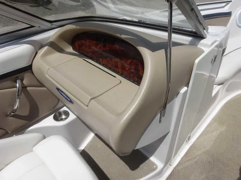 Slide: The Image of 2006 Four Winns H220 boat interior with beige dashboard and wood accents. - 15