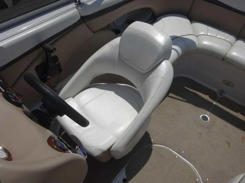 Slide: The Image of 2006 Four Winns H220 boat interior with white seating and steering wheel. - 5