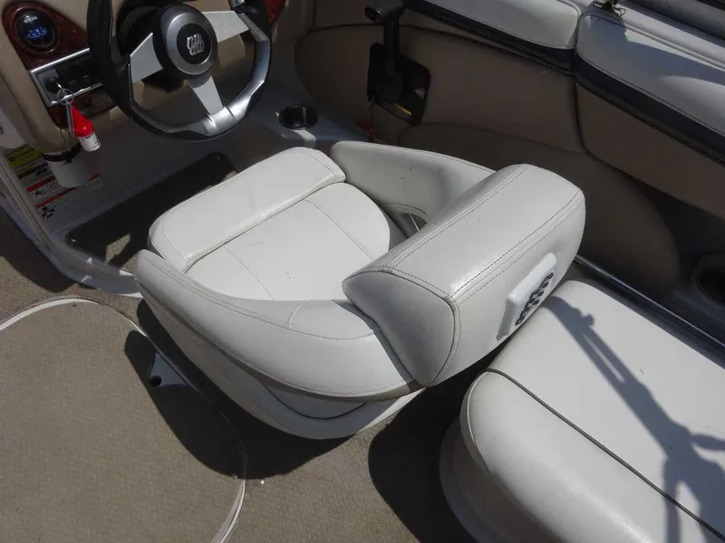 Slide: The Image of 2006 Four Winns H220 boat interior with white leather seating and steering wheel. - 6
