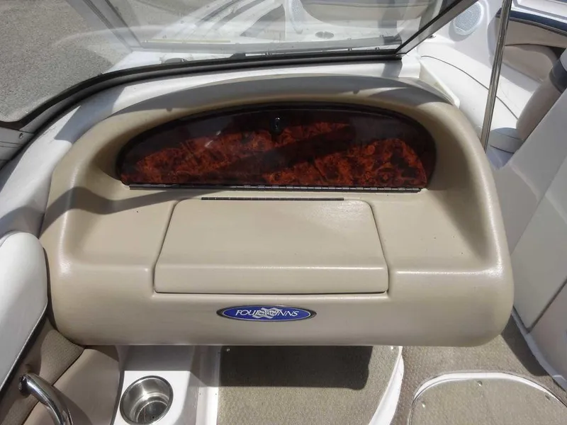 Slide: The Image of 2006 Four Winns H220 boat dashboard with wood trim and logo. - 9
