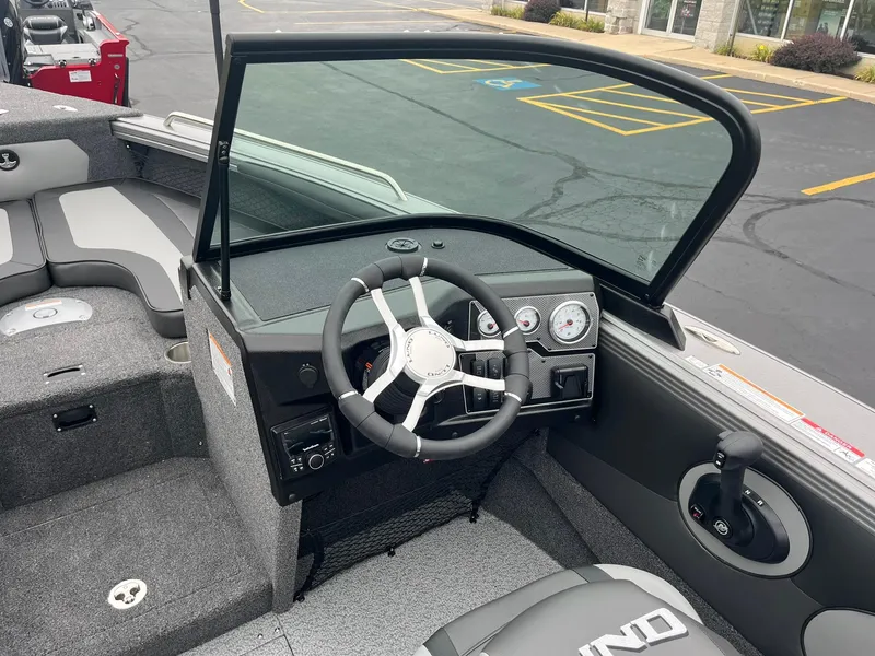 Slide: The Image of 2025 Lund 1875 Tyee boat interior with steering wheel and dashboard controls. - 15