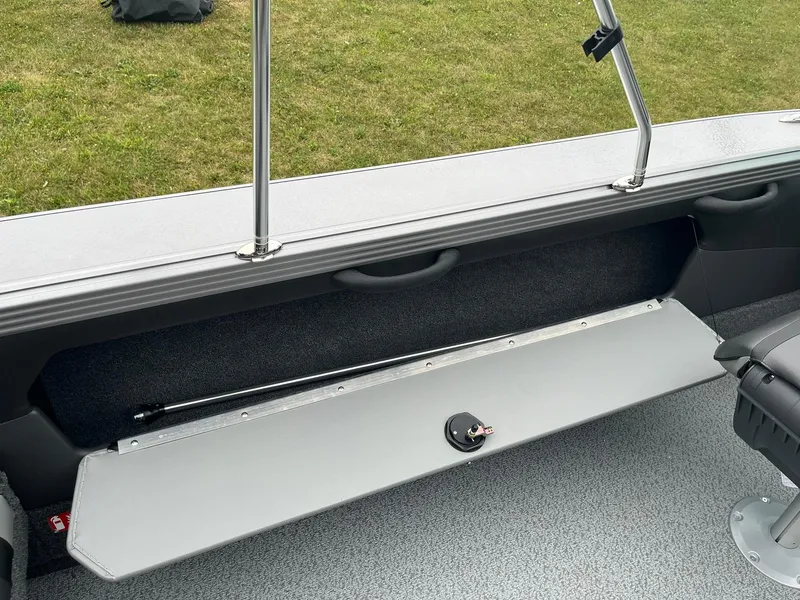 Slide: The Image of 2025 Lund 1875 Tyee boat storage compartment with open lid, showcasing interior space. - 22