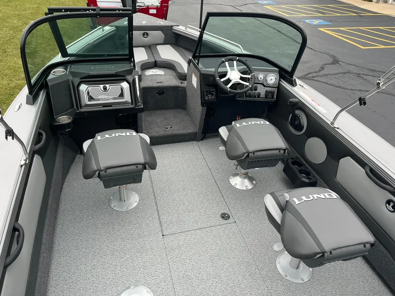Slide: The Image of Interior of 2025 Lund 1875 Tyee boat with gray seating and steering console. - 6