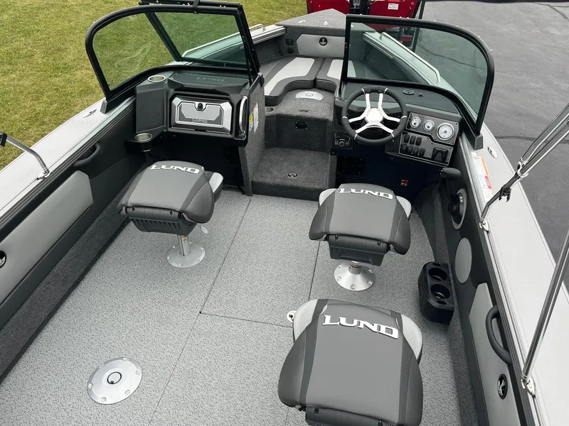 Slide: The Image of 2025 Lund 1875 Tyee boat interior with seating and steering console. - 7