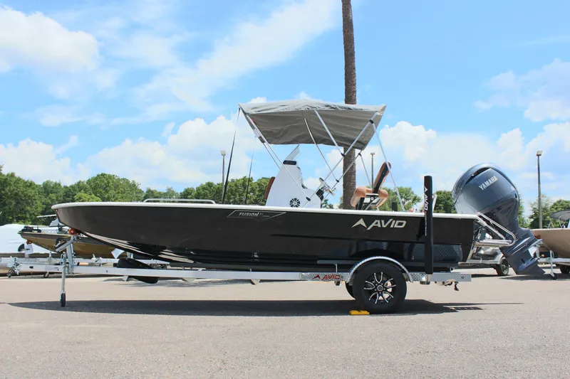 Slide: The Image of 2024 Avid 21 Fusion boat on trailer with Yamaha outboard motor. - 1